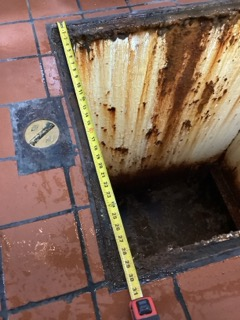 Tape measure showing the inside dimension of an existing grease trap